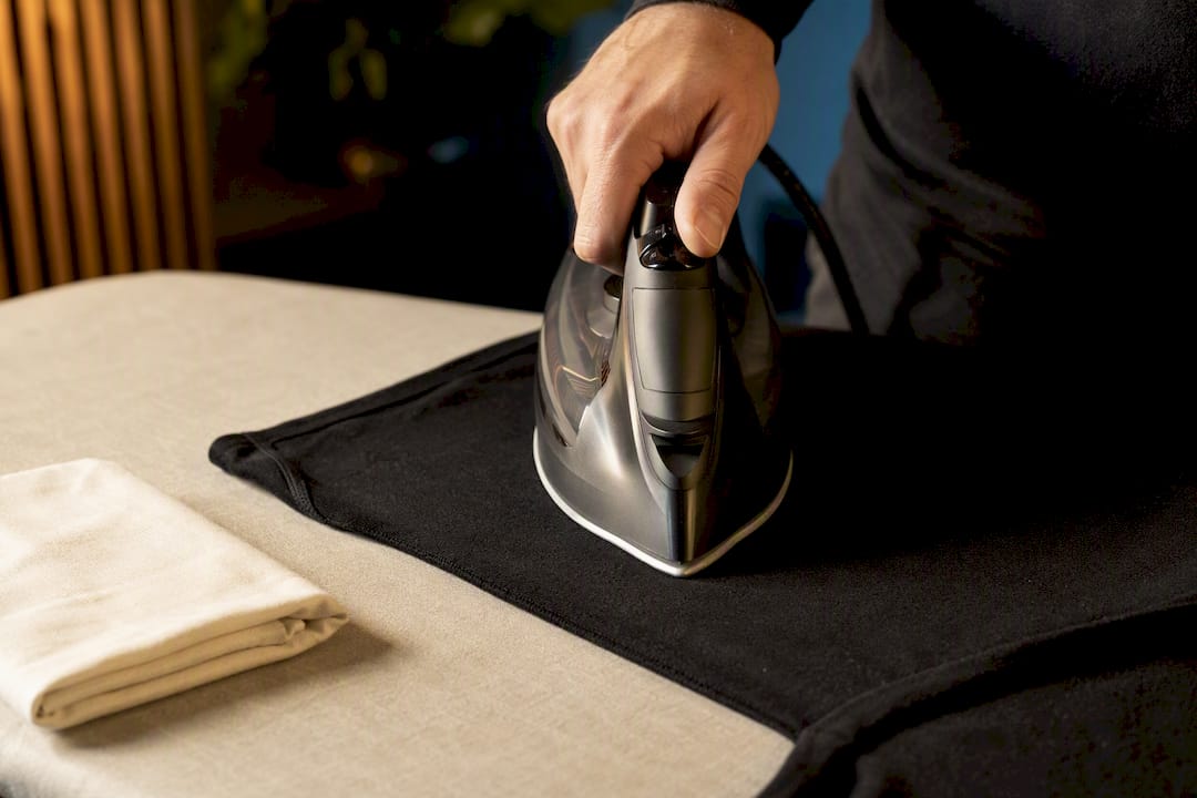 Iron pressing garment inside out with cloth barrier