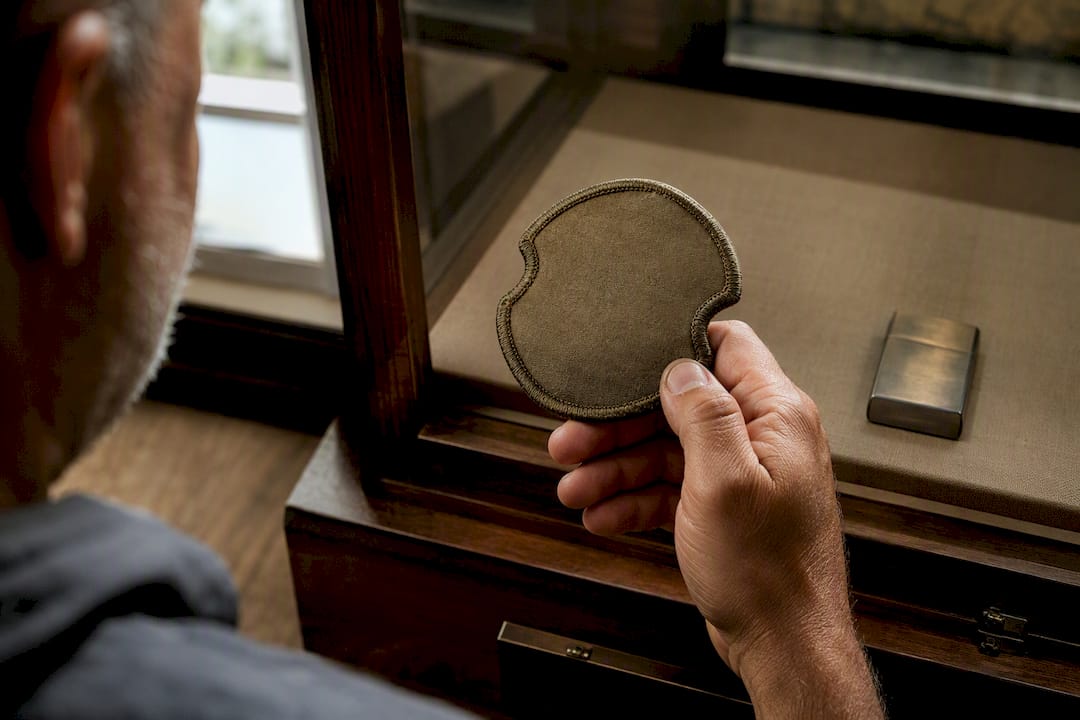 Veteran examining an anonymous embroidered unit patch