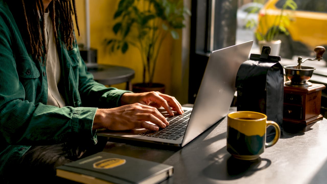 Hands selecting coffee subscription preferences on laptop