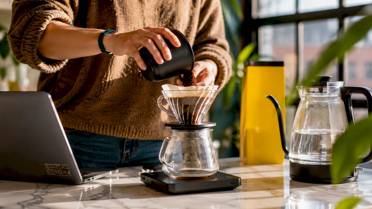 Close-up hands preparing quality coffee at home