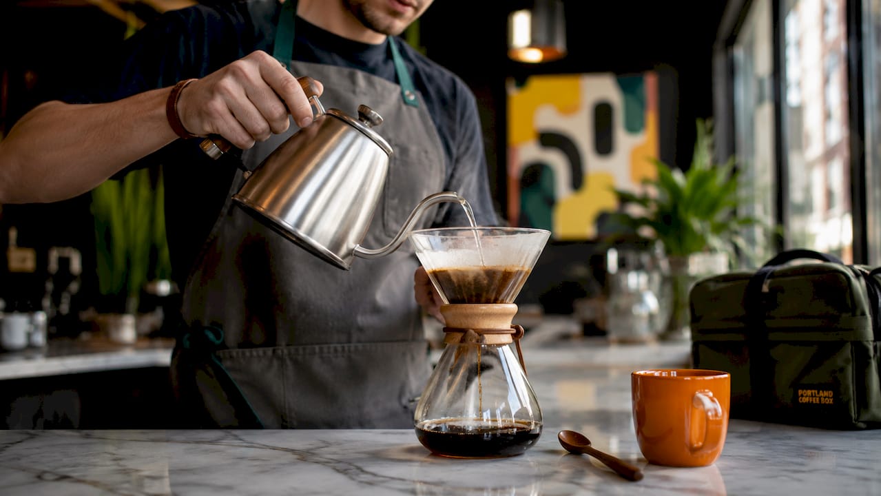 Barista pouring water for coffee bloom test