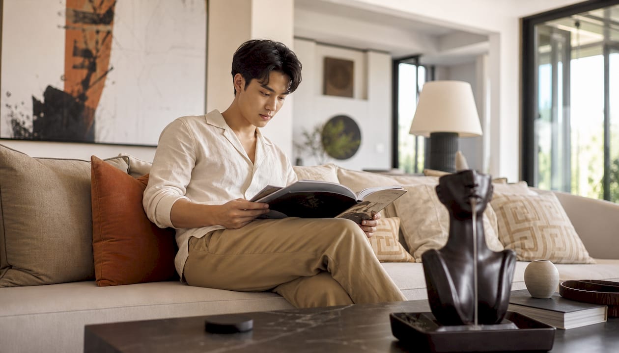 Man reviewing design catalog in modern living room