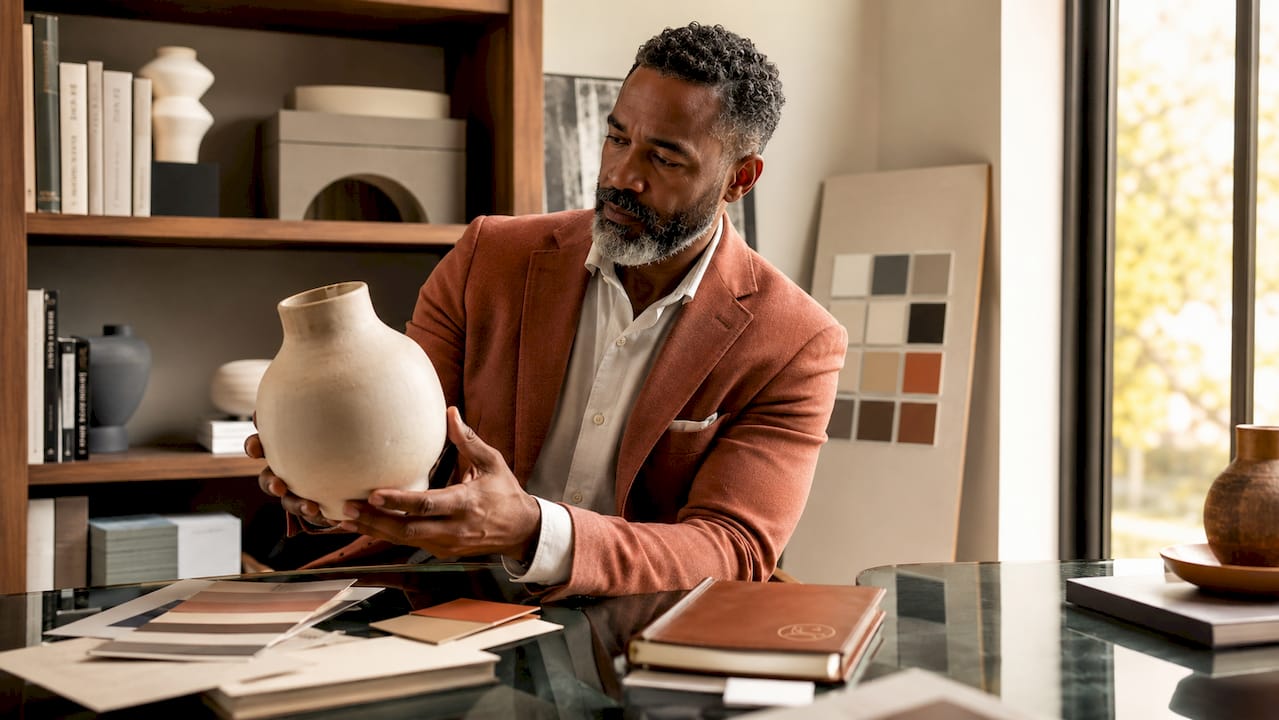 Man examining curated home decor sculpture