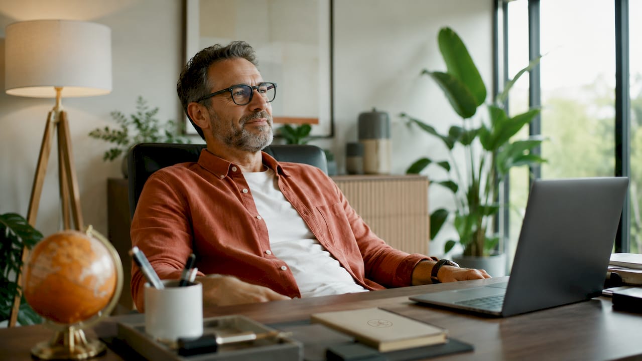 Man adjusting desk lamp in professional office lighting