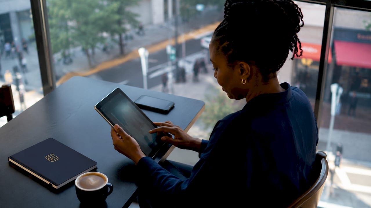 Woman monitoring analytics on dual screens