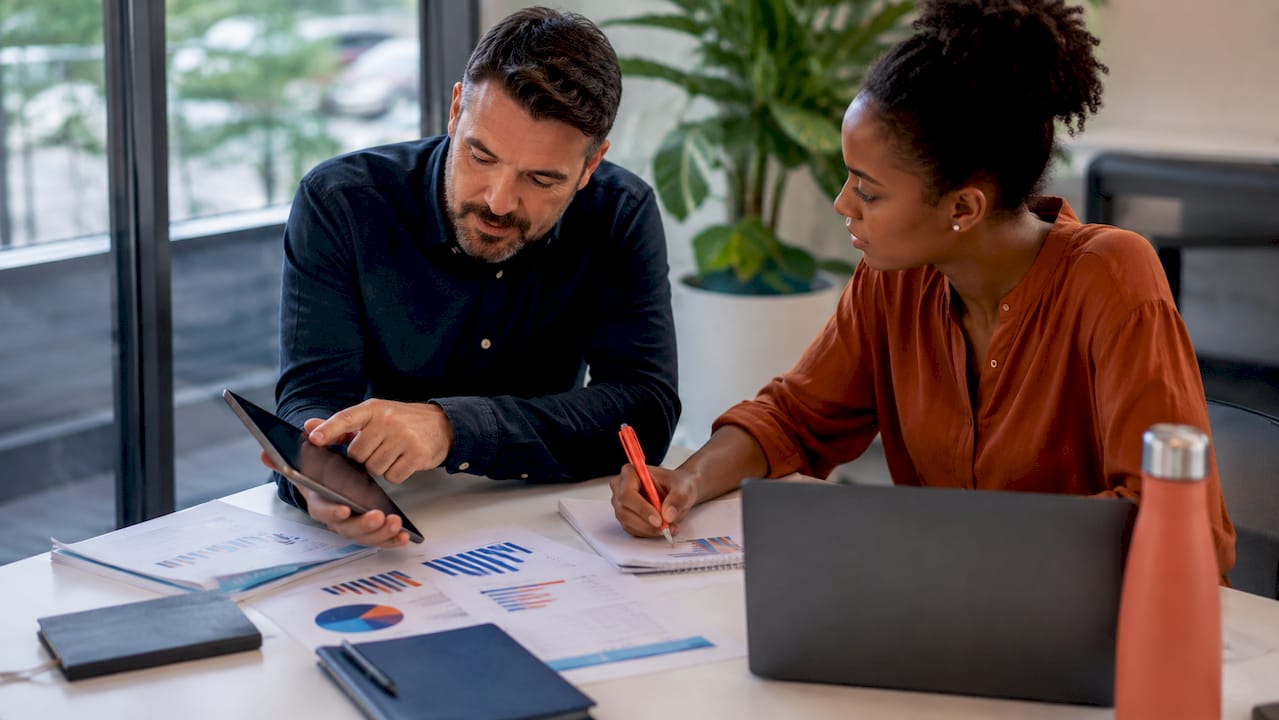 Professionals discussing finance hiring strategy