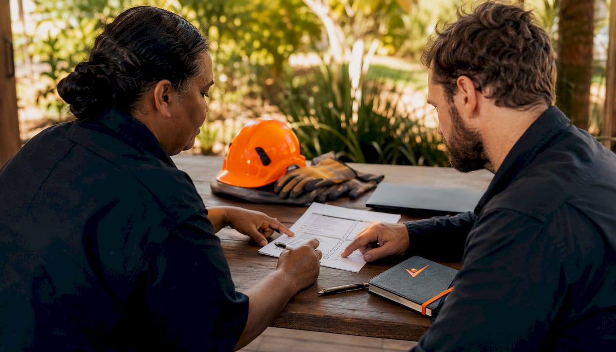 Hands reviewing safety checklist during electrician hiring