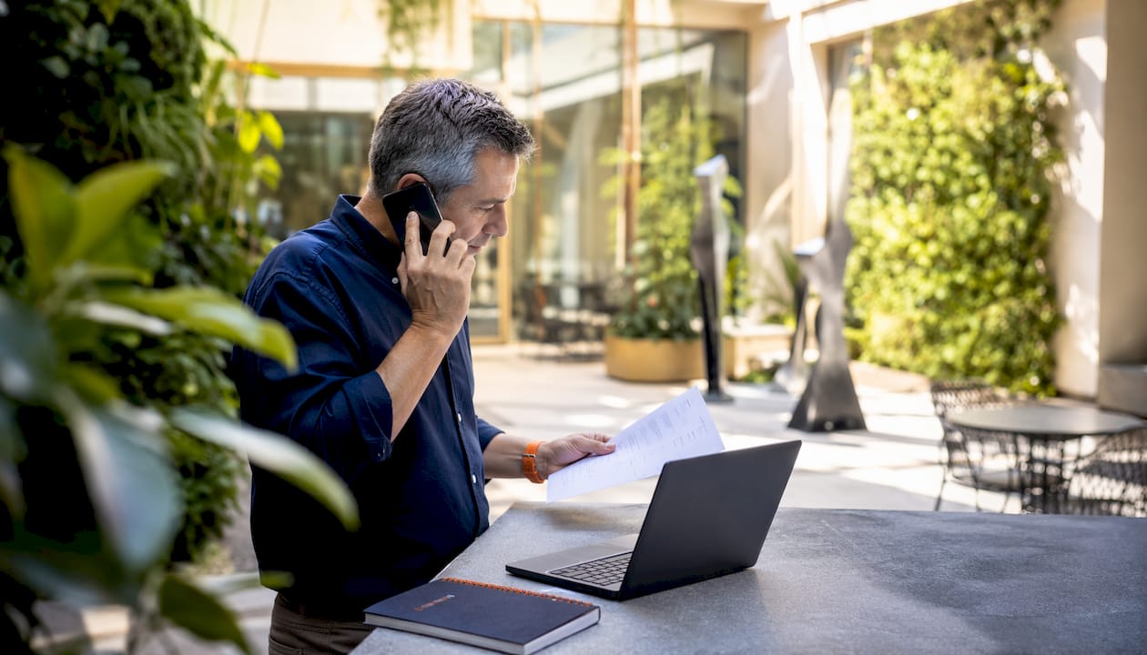 Man setting up payroll documents at office desk