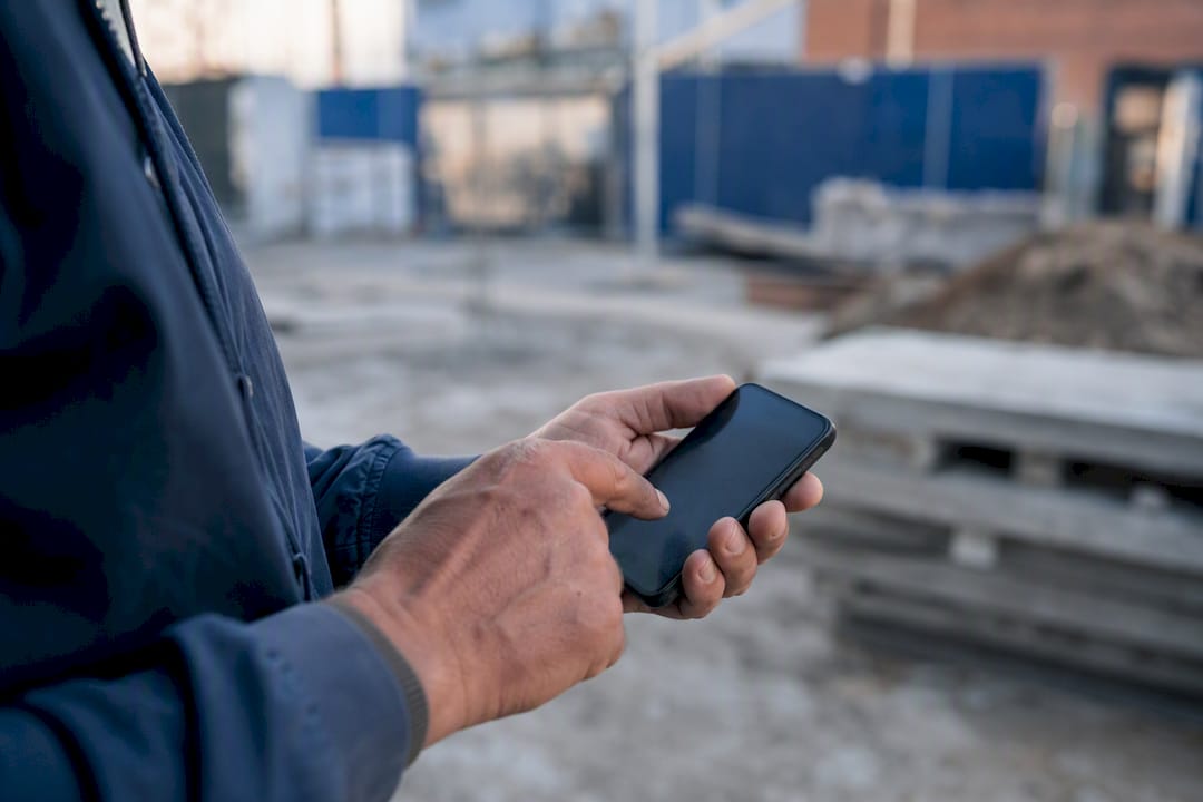 Hands tapping smartphone to fill digital form