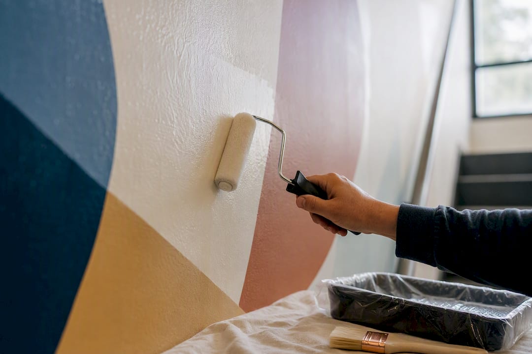 Applying protective topcoat to school mural