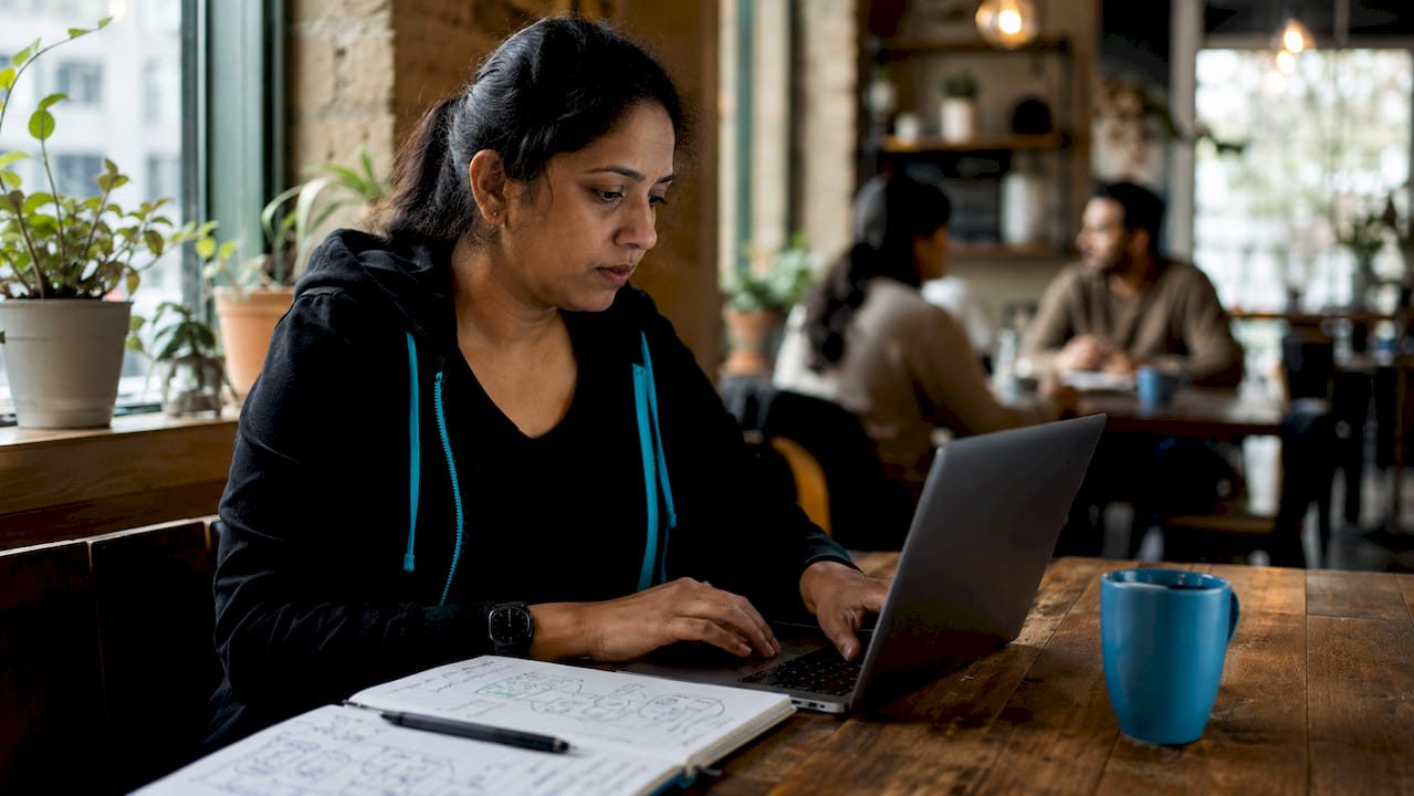 DevOps engineer working with feature flags at laptop