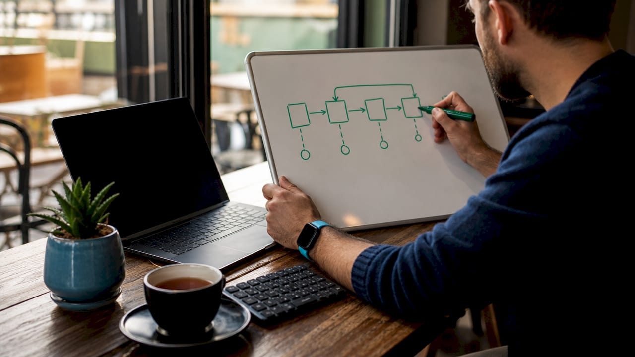 Close-up of hands sketching GitLab job sequence diagram
