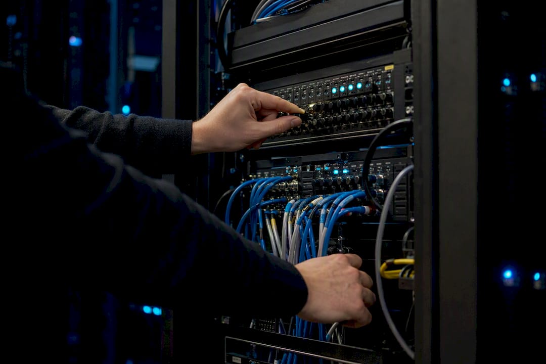 Hands adjusting cloud service infrastructure rack