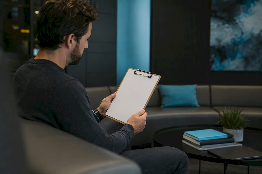Hands with clipboard in server room during incident workflow