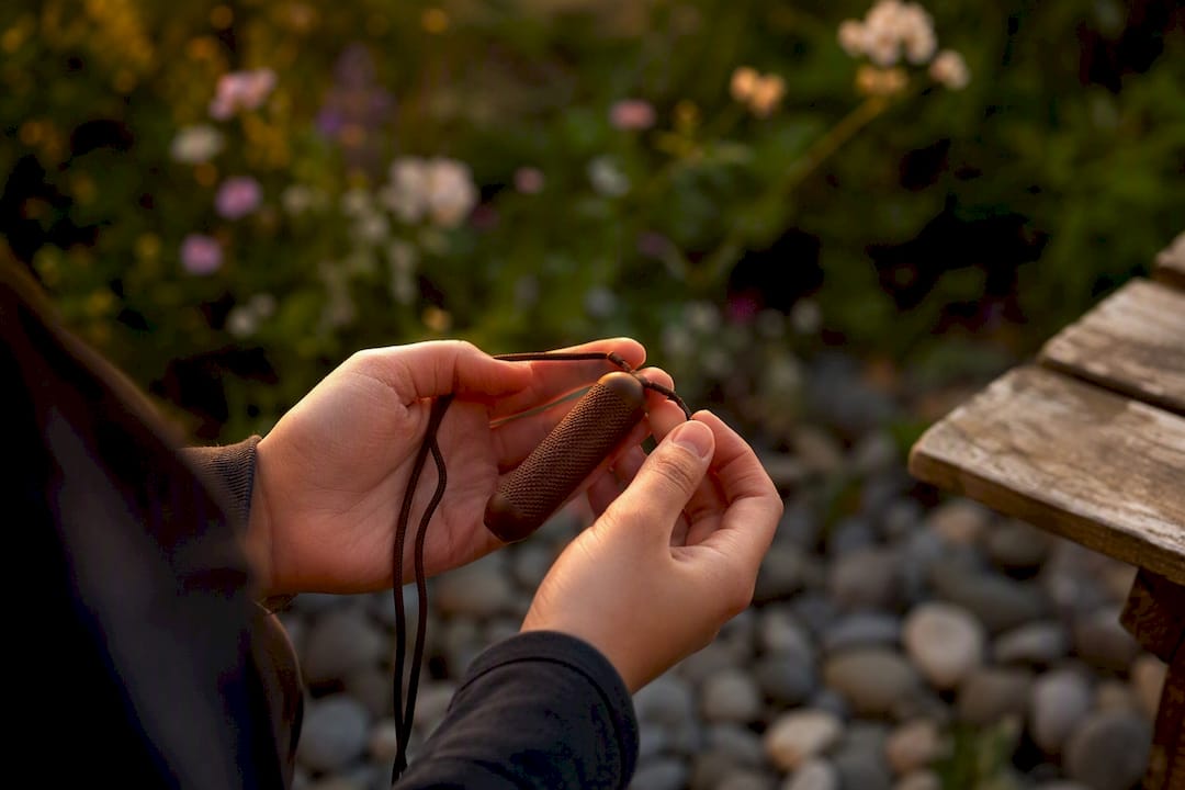 Hands holding resistance necklace detail