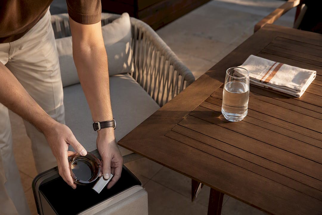 Hands removing smoking cues from patio