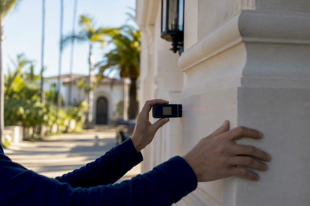 Appraiser measuring luxury home exterior