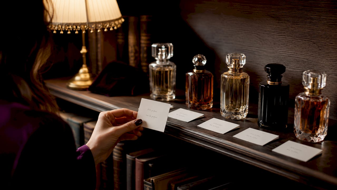Close-up of perfume bottles with concentration cards
