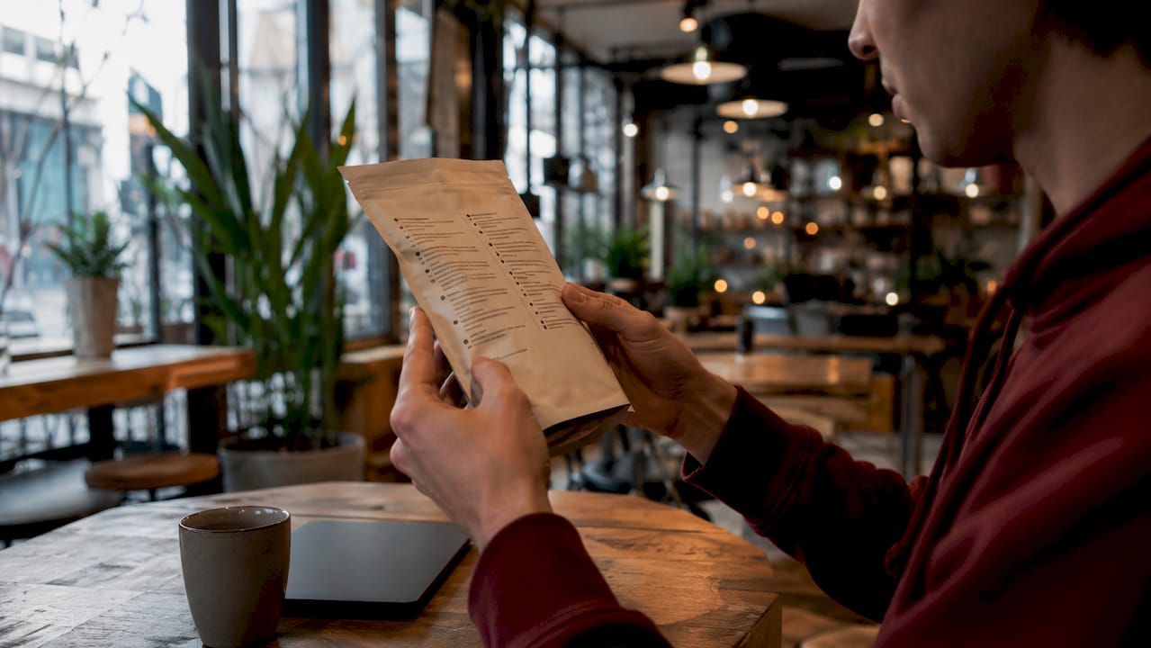 Close-up of hands reading food ingredient label