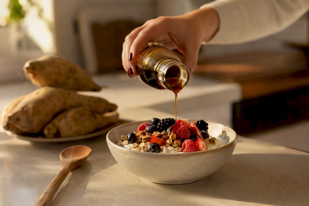 Yacon syrup drizzling on yogurt and berries