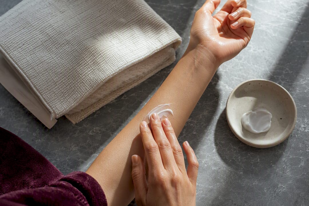Hands moisturizing skin before fragrance application