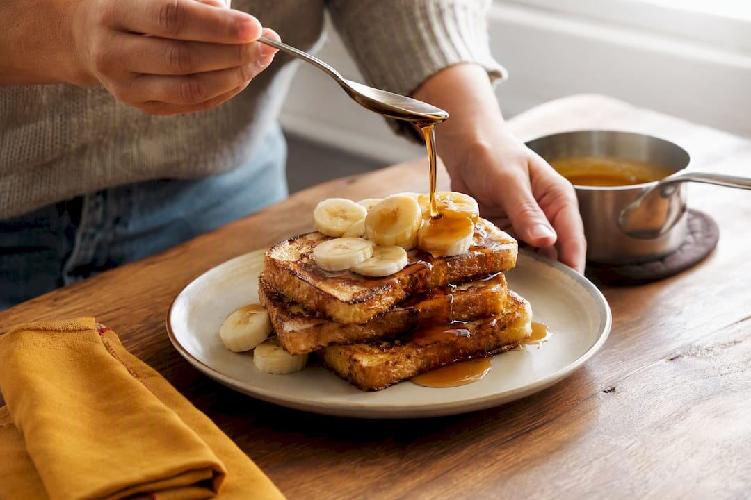 Warm syrup swirled over banana French toast
