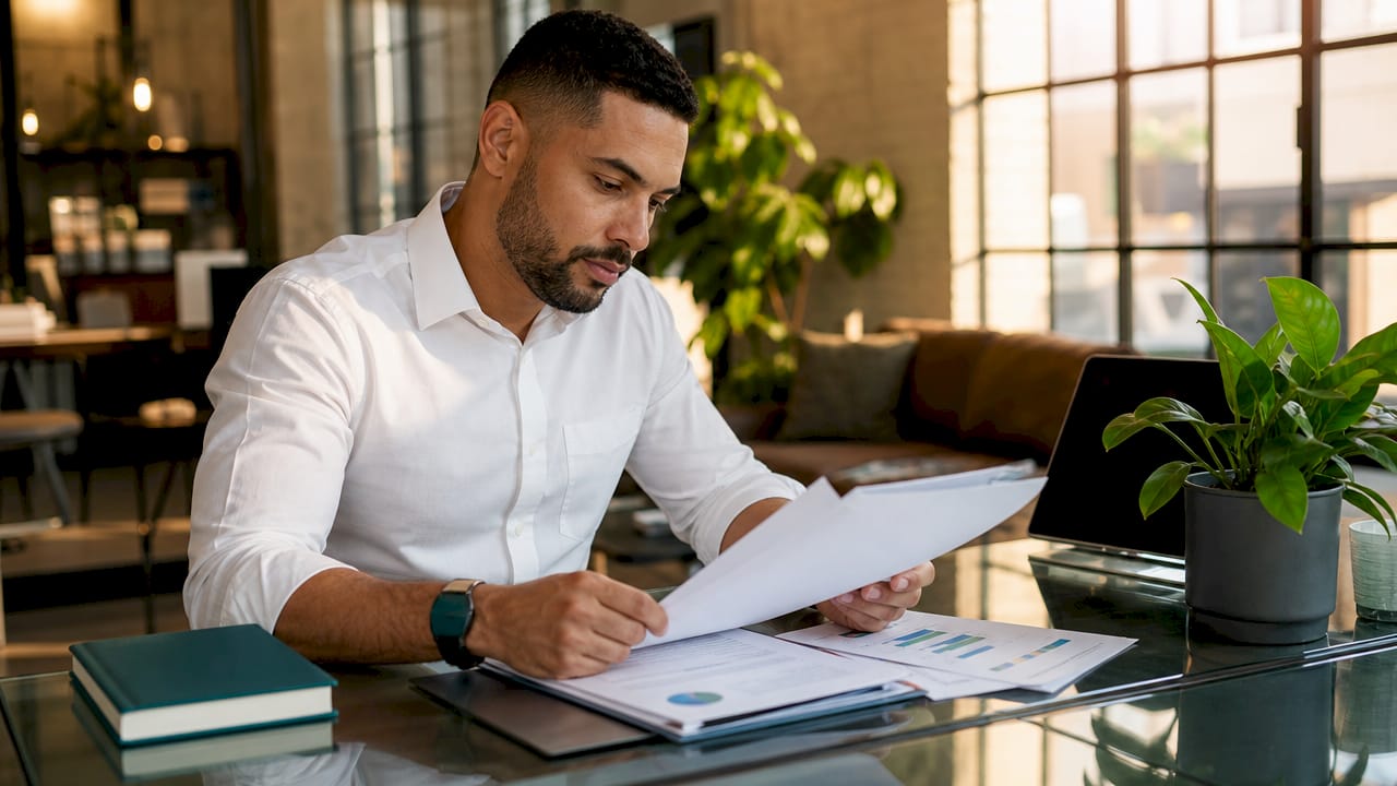 Hands reviewing ESG governance papers on desk