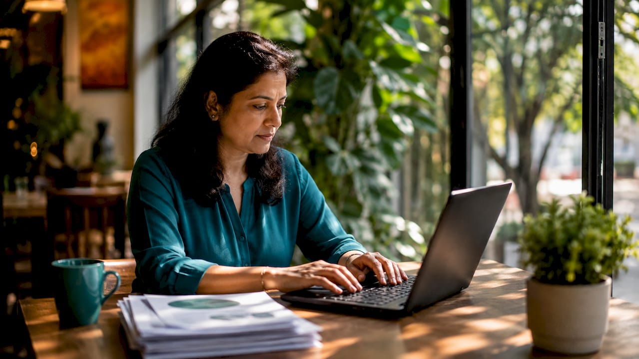ESG staff member typing at shared workspace