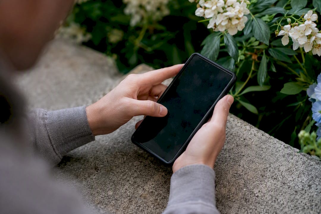 Hands long-pressing smartphone to preview link