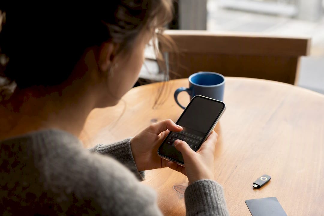 Hands setting up password on smartphone