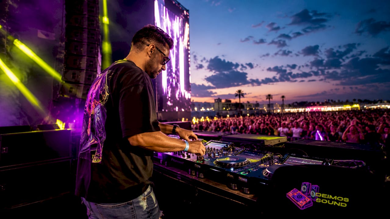 DJ mixing live with mixer and headphones