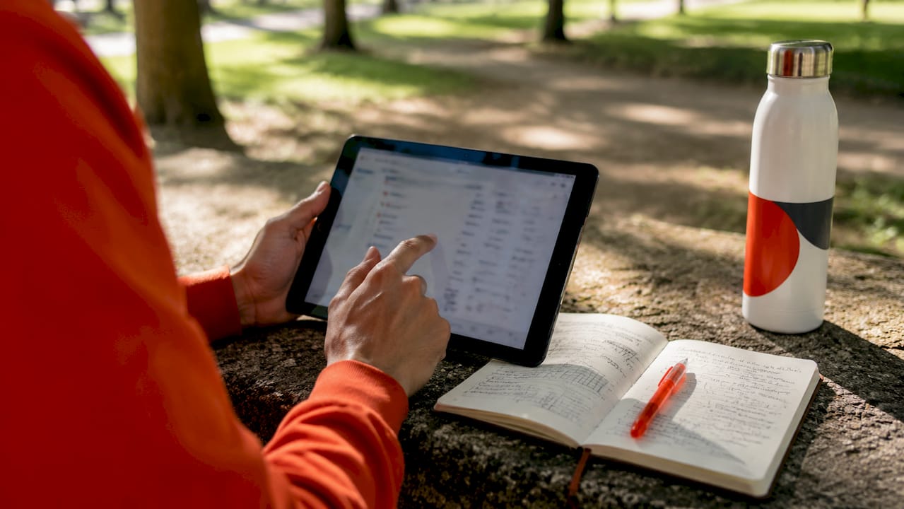 Hands using tablet for voice keyword research