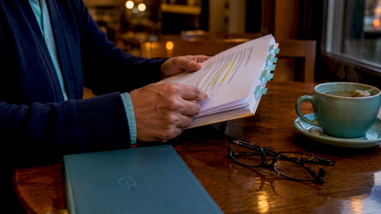 Hands flipping federal law booklet