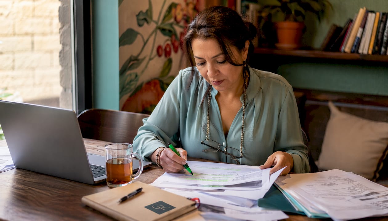 Woman reviewing insurance documents at home