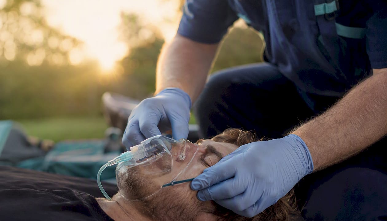 Hands applying oxygen mask in emergency