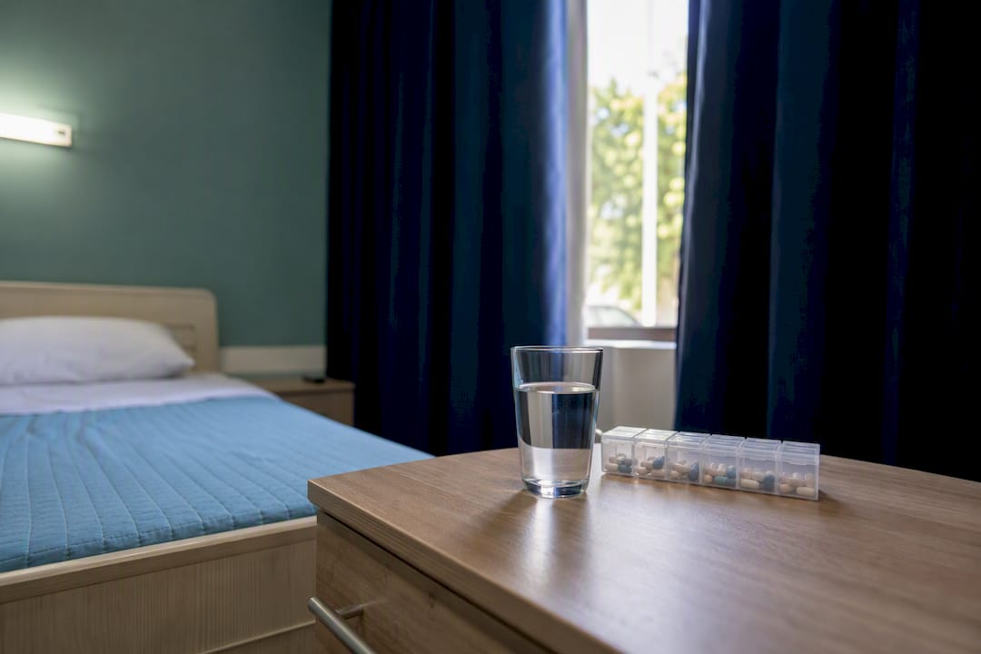 Clinical detox room with medication on bedside table
