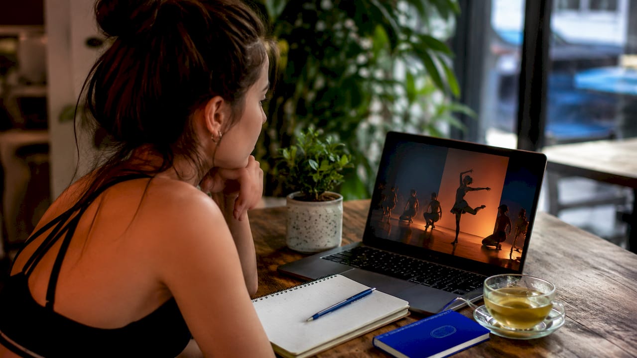 Young dancer watching live dance performance in theater