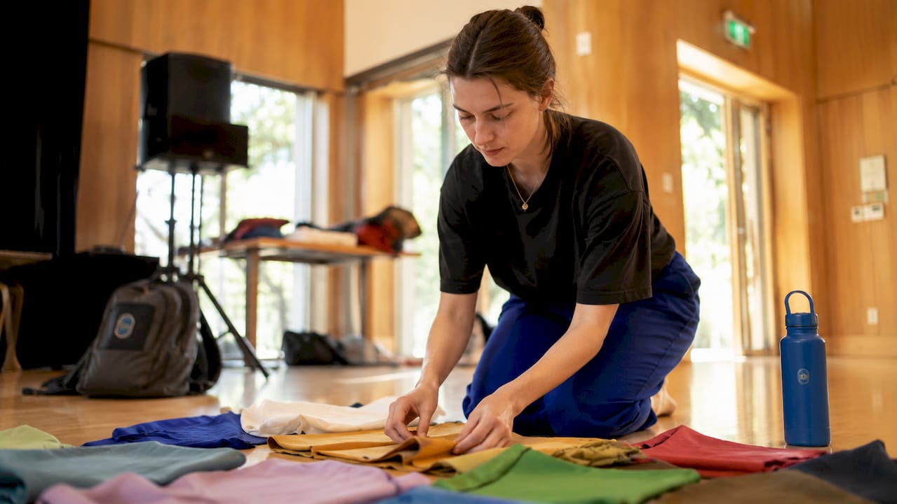 Artist preparing sparse theater stage