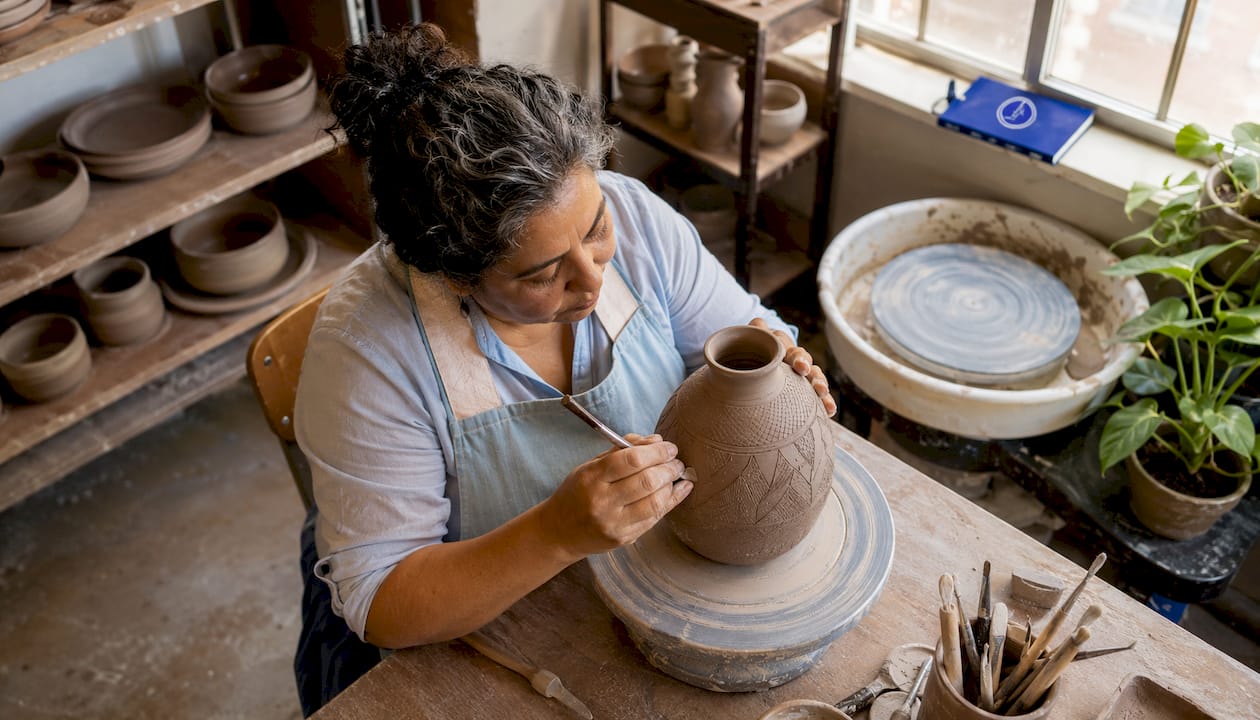 Pottery artist shaping clay in Denver studio