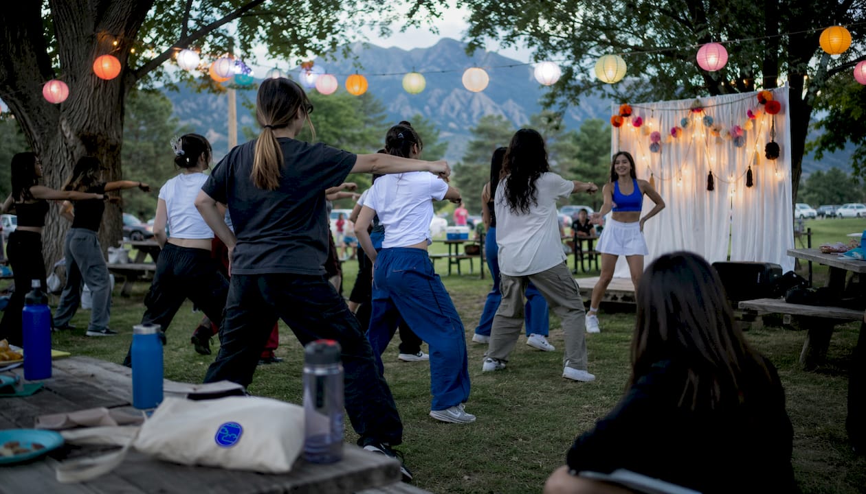 Community members dancing K-pop outdoors at Colorado event