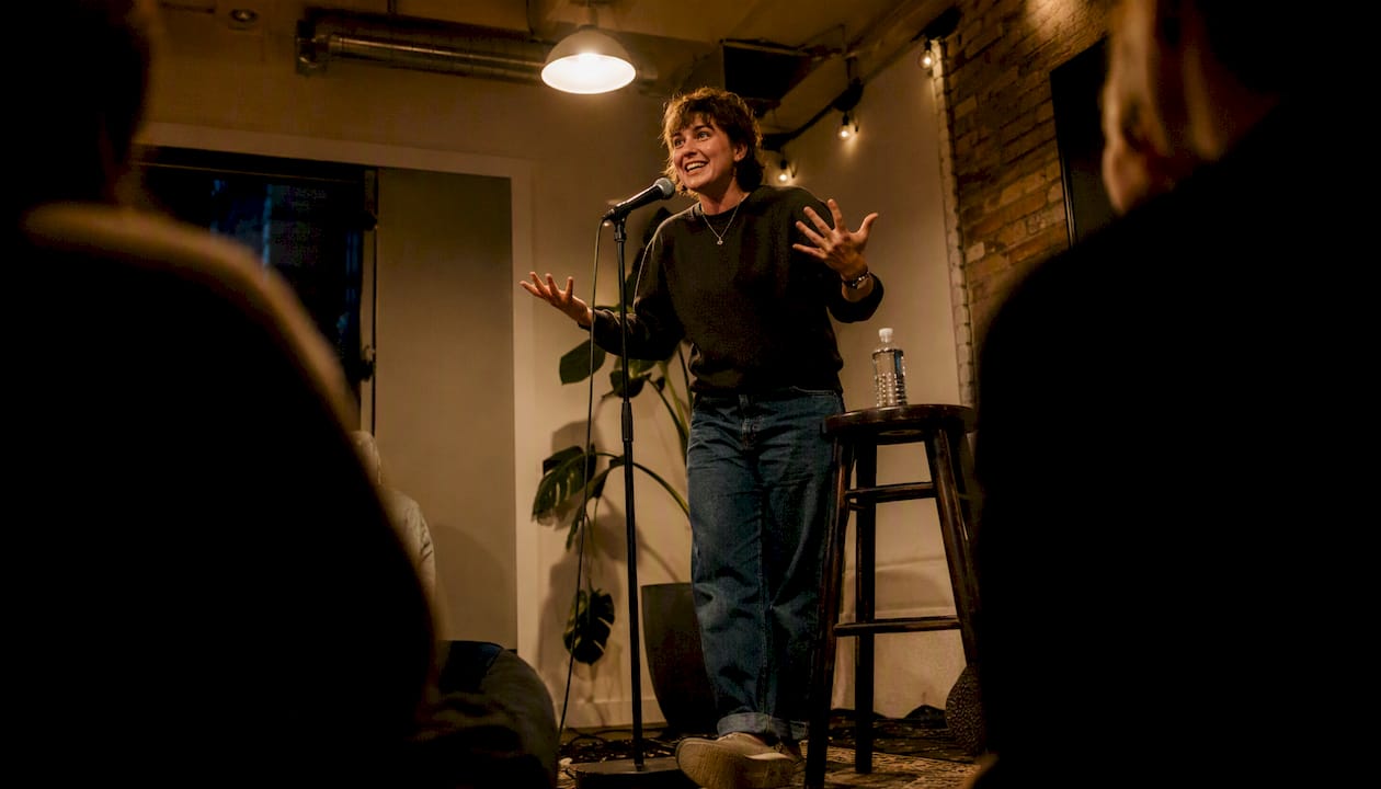 Local comedian performing stand-up on intimate stage