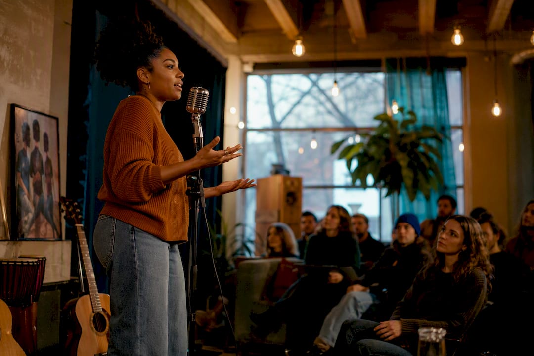 Poetry slam performer on stage at Denver venue