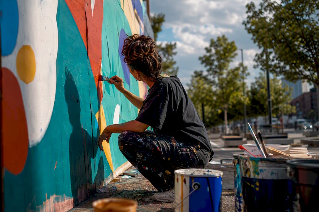 Artist painting colorful outdoor pop-up mural
