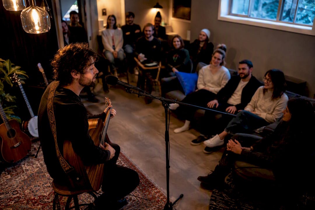 Intimate Denver house concert audience listening