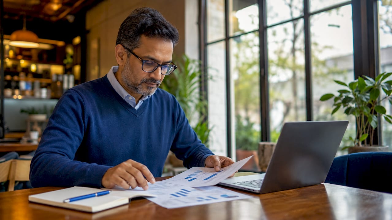 Man arranging AI lead scoring model documents