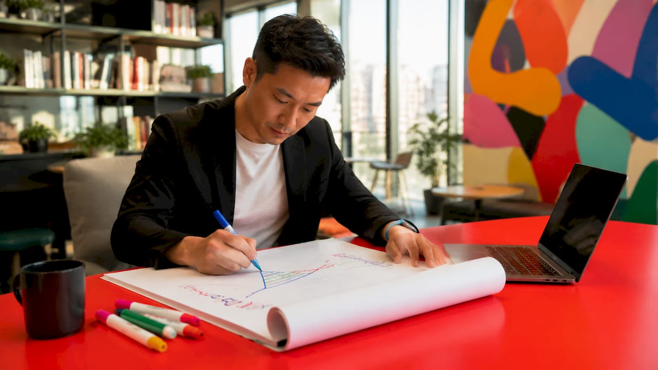 Man drawing marketing funnel on whiteboard