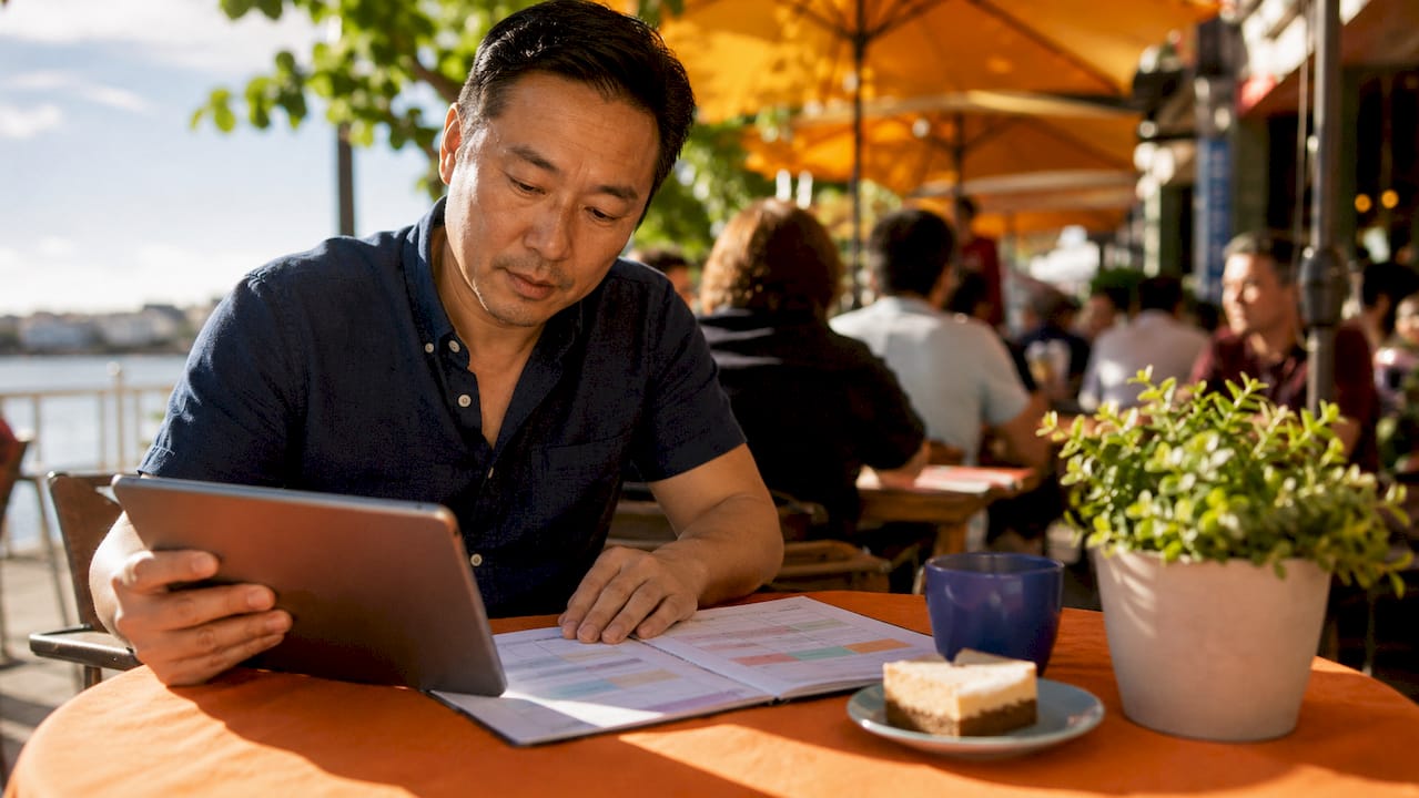 Man planning weekly marketing routine in cafe setting