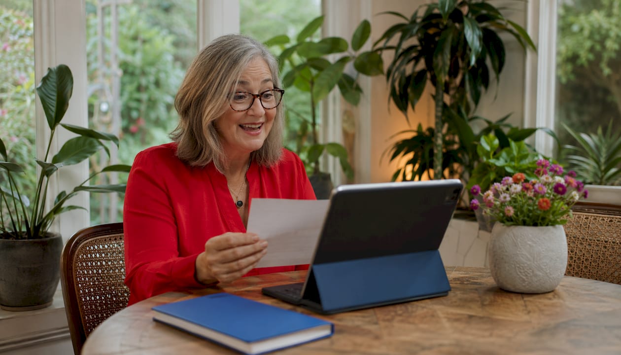 Woman reading testimonial during video call at home office