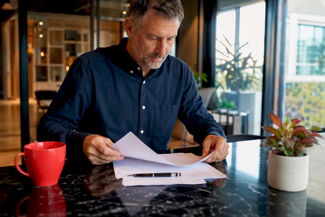 Hands arranging briefing papers on desk