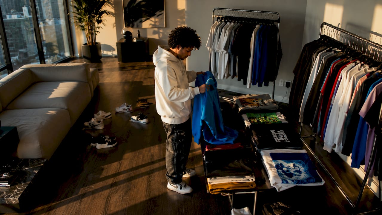 Person organizing streetwear wardrobe